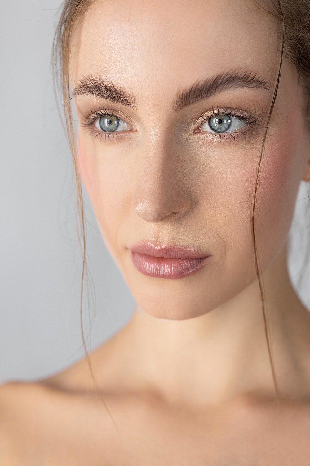 Close-up of a woman's face with natural makeup.