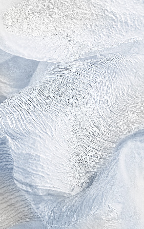 Textured white fabric with soft, flowing waves.