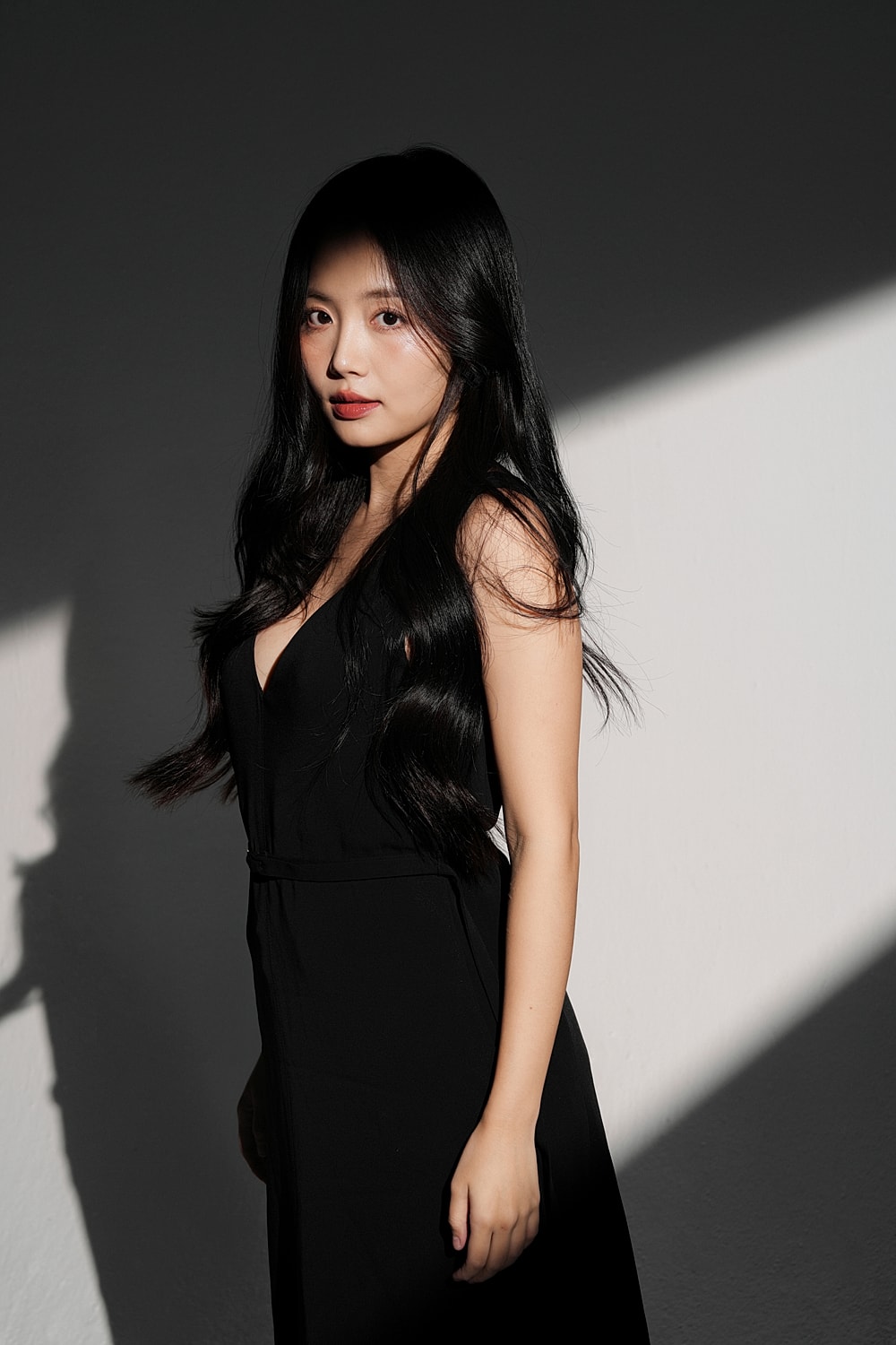 Woman in black dress with long, flowing hair.